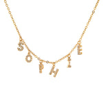 Gold necklace with letter charms on a white background